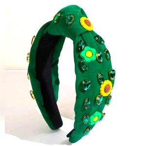 Green headband with knot design with stones and flowers